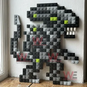 Pixel style alien creature made from small building bricks displayed on a wooden floor against a wall!