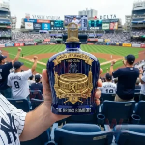 A blue and gold Yankees anniversary bottle is held in front of a crowded baseball stadium during a live game!