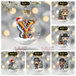 Multiple clear ornaments feature Yellowstone themed figures and a light wrapped emblem set in snowy scenes.