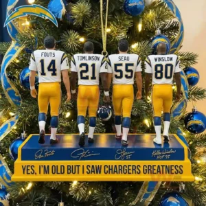 Four Chargers figures in white and yellow uniforms stand on a display base with a Christmas tree decorated in blue and gold behind them!