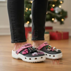 YUNGBLUD Christmas Crocs Clogs with Charms 4 Feet wearing Yungblud themed clogs decorated with punk style charms such as hearts microphones holly and drumsticks.
