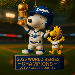 Ornament of Snoopy in a Dodgers uniform holding a trophy with Woodstock beside him on a base honoring the two thousand twenty five Los Angeles Dodgers championship!