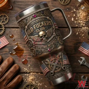 A metal tumbler with skull and gear artwork placed on a wooden table with tools and mechanical elements!