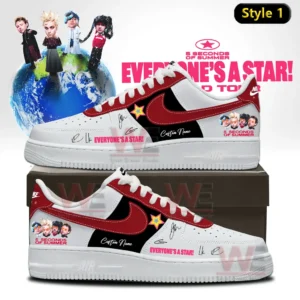 Two custom low top sneakers in white red and black featuring 5 Seconds Of Summer graphics star emblem and Everyone s A Star text displayed on a shoe box with a band themed background!