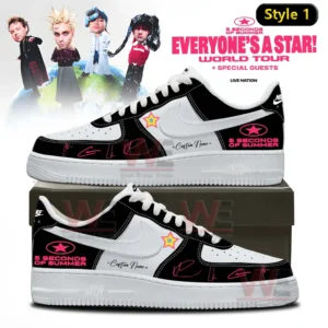 Two custom black and white low top sneakers with 5 Seconds Of Summer logos star patch and pink signature accents displayed on a shoebox with Everyone s A Star World Tour background!