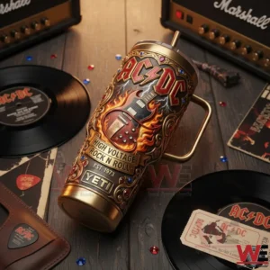 An AC DC insulated tumbler placed among vinyl records amplifiers and rock music memorabilia on a wooden table!