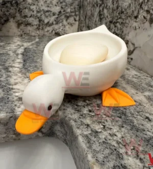 Duck shaped soap dish with a bar of soap displayed on a granite bathroom counter!
