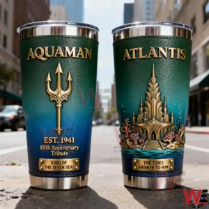 Two Aquaman inspired tumblers with ocean blue green tones gold trident symbol Atlantis city artwork and luxury finish displayed on a city street background!