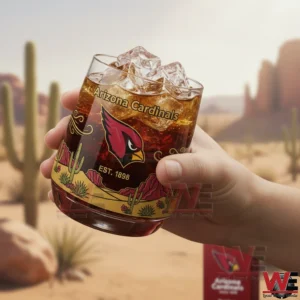 Hand holding an Arizona Cardinals whiskey glass with bird logo ice cubes and desert themed artwork!