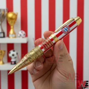 Bayern Munich anniversary ballpoint pen held by hand with gold engravings and red barrel design!