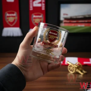Arsenal FC 140th Anniversary Collectors’ Whisky Glass 3 Handheld Arsenal themed whisky glass featuring the club crest and anniversary design with football memorabilia in the background!
