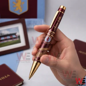 Aston Villa Official Limited Edition Pen 3 A Hand Holding An Aston Villa Themed Burgundy And Gold Pen With The Club Logo And Decorative Gold Pattern.
