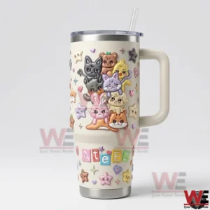 Cream colored insulated tumbler with handle and straw covered in adorable cartoon animals and Ateez text!