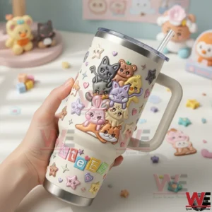 Hand holding a cream insulated tumbler with handle featuring adorable animal characters and Ateez text!