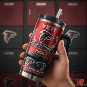 Hand holding a red Atlanta Falcons Yeti tumbler with a straw and sixtyth anniversary design showing established nineteen sixty six and the Falcons logo!