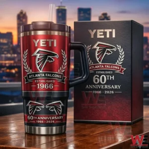 Atlanta Falcons 60Th Anniversary Limited Edition 1966-2026 Yeti Tumbler 4 Atlanta Falcons Yeti tumbler with handle and straw shown beside a matching sixtyth anniversary gift box on a table with a city skyline in the background!