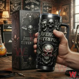 Hand holding a black skull designed insulated tumbler with handle in front of a music studio background!