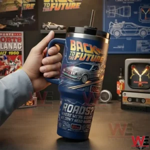 Hand holding a Back to the Future themed insulated tumbler with DeLorean artwork in front of a retro movie display!