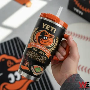 Hand holding a black and orange Yeti tumbler with Orioles 125th anniversary graphics and baseball icons!