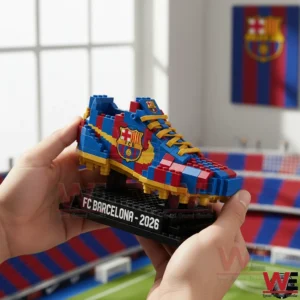 A close view of a FC Barcelona themed soccer boot model constructed from building blocks placed on a black display stand in a football stadium!