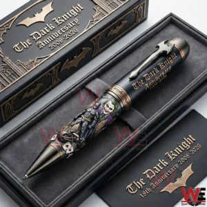 A Dark Knight anniversary collectible pen displayed in a black presentation box with Batman and Joker artwork and gold decorative details!
