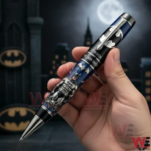 Batman The Dark Knight 1939-2026 87th Anniversary Pen 3 A Close Up Of A Batman Themed Pen In A Person Hand With Metallic Finish And Gotham Style Background Elements!