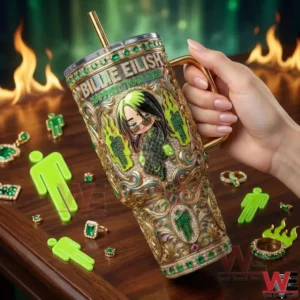 Hand holding an ornate gold and green tumbler against a dramatic background!
