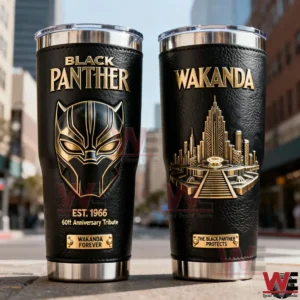 Two Black Panther insulated tumblers with black textured surface gold lettering anniversary tribute mask emblem and a three dimensional Wakanda city design displayed in an outdoor setting!