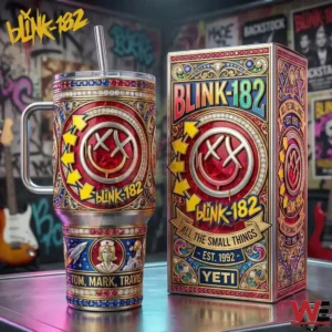 A decorative Blink 182 tumbler with a red smiley logo gold ornament details and a matching display box placed on a tabletop in a music studio!