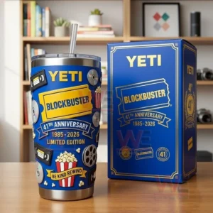 Yeti Blockbuster 41st Anniversary tumbler with a straw and retro movie graphics displayed beside a matching blue gift box on a table in a home setting!