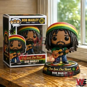 Bob Marley inspired pop style figure with dreadlocks and red yellow green cap holding a guitar beside a themed display box on a wooden table by a window!