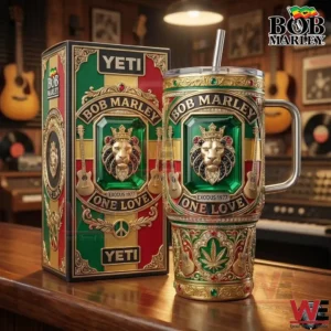 Metal tumbler with lion crest reggae color design and music symbols standing next to a decorated box on a wooden surface!