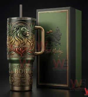 Green insulated tumbler with lion artwork and handle standing next to a matching box on a dark background!