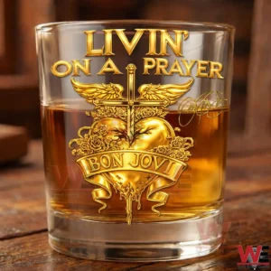 Close up of a whiskey glass with gold LIVIN ON A PRAYER BON JOVI artwork on a wooden surface!