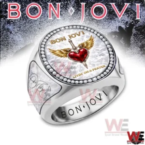Silver Bon Jovi themed ring with a winged heart and dagger emblem on a gem bordered face displayed on a bright background.