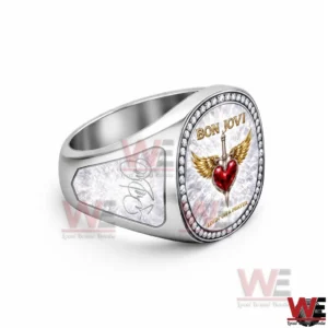 Bon Jovi Livin' On A Prayer Luxury Ring 5 Side view of a silver Bon Jovi ring highlighting the thick band and the round emblem with a winged heart and dagger.