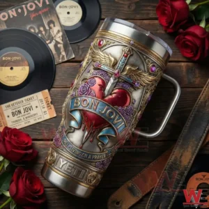 A Bon Jovi insulated tumbler placed on a wooden table with vinyl records roses and rock music memorabilia!