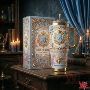 Elegant insulated tumbler with floral ornaments crown emblem and handle standing next to a decorative box in a vintage style room!