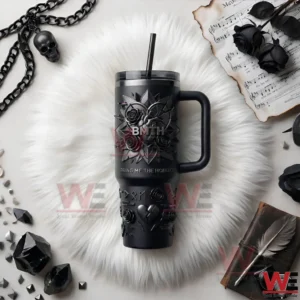 A Bring Me The Horizon insulated tumbler placed on a white textured surface with dark themed accessories!