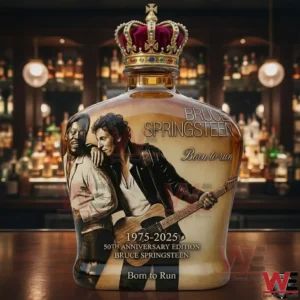 Alt text Crowned whiskey bottle with Bruce Springsteen Born to Run 1975 2025 anniversary label displayed on a bar counter!