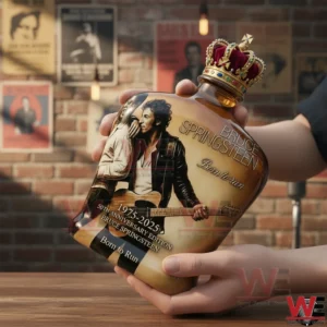 Alt text Hands holding a crowned Bruce Springsteen Born to Run 1975 2025 anniversary whiskey bottle against a brick wall!