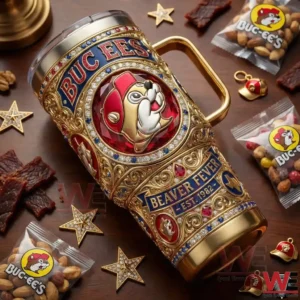 Gold detailed Buc Ees tumbler lying on a table surrounded by branded snacks and small items!