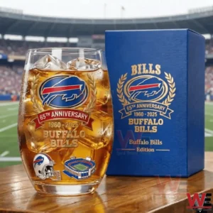 Buffalo Bills sixty five year anniversary whiskey glass with team logo gold laurel design and commemorative details placed on a wooden table inside a football stadium!