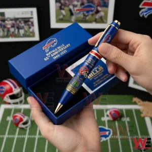 Hands holding a Buffalo Bills 65th anniversary 1960 2025 collectible pen inside a blue presentation box with team logos a stadium illustration and football themed decor in the background!