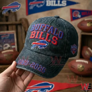 Hand holding football team cap with fan decorations and sports items behind!