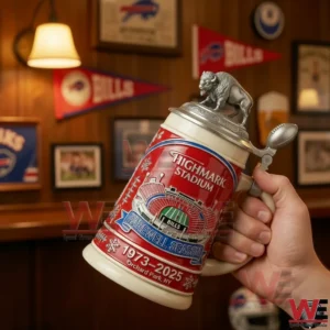 Hand holding a red Buffalo Bills Highmark Stadium farewell season beer stein with buffalo lid topper and stadium graphic in a sports bar style room.