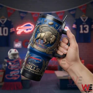This image presents a close view of a Buffalo Bills legacy tumbler held indoors highlighting the textured surface bold team imagery and passionate fan environment!