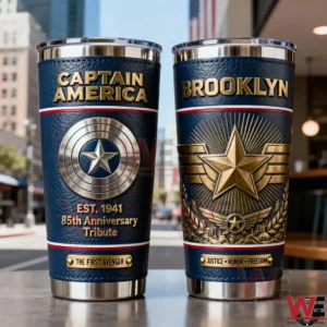 Two Captain America insulated tumblers with blue textured exterior gold lettering shield emblem anniversary tribute and a strong patriotic design displayed in a city setting!