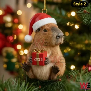 Capybara Christmas ornament wearing a Santa hat and holding a red 2025 gift with a glowing holiday tree background!