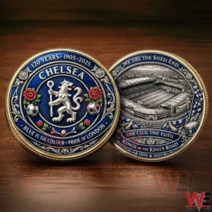 A two sided commemorative football coin with ornate blue gold detailing roses football elements and a stadium scene placed on a wooden background!